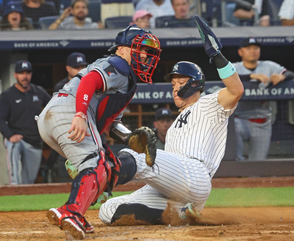 Aaron Judge slides safely into home to score on Gleyber Torres' two-run double  in the third inning of the Yankees' victory.