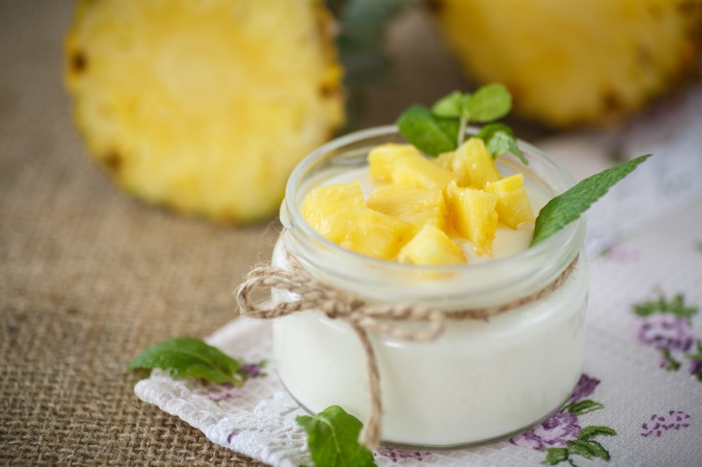 sweet homemade yogurt with pineapple in a glass jar