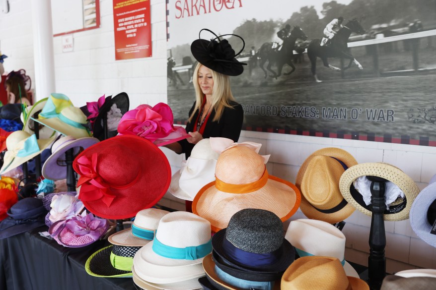 Kim DiStefano of Willamstown, NY selling hats at Saratoga for Belmont Stakes.