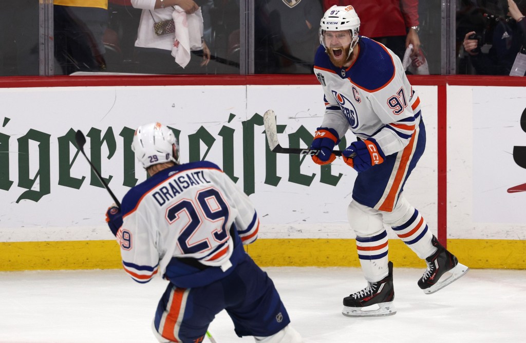 Connor McDavid celebrates after scoring the game-clinching empty net goal to give the Oilers a 5-3 win over the Panthers in Game 5 of the Stanley Cup Finals.