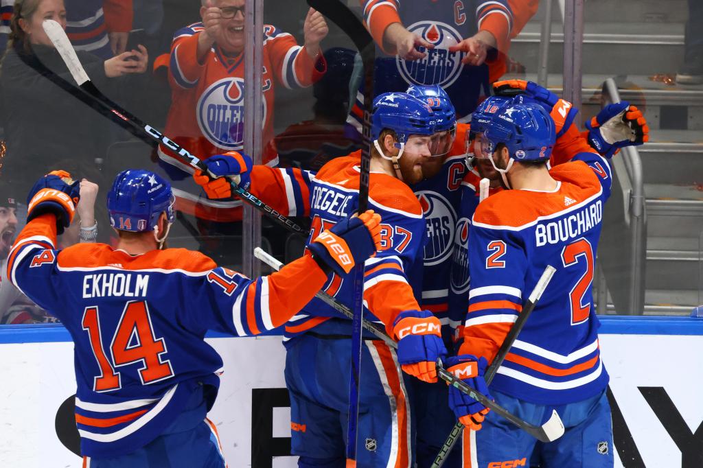 Connor McDavid (wearing the captain's C) is mobbed by teammates after scoring a second period goal in the Oilers' 8-1 blowout win over the Panthers in Game 4 of the Stanley Cup Finals.