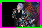 Cyndi Lauper sings onstage with a microphone in hand.