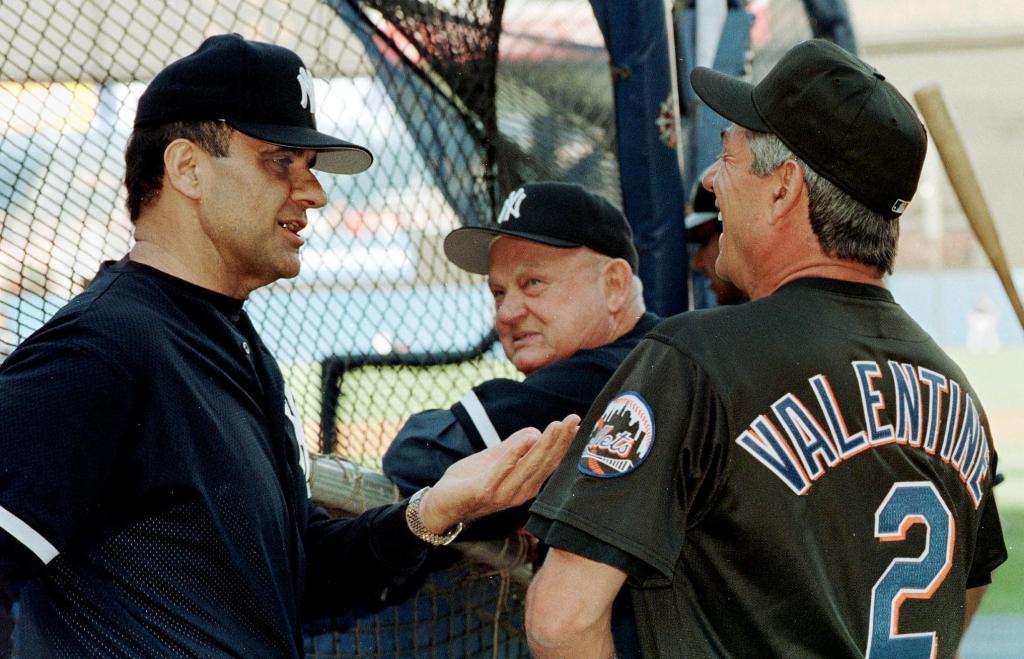 New York Yankees manager Joe Torre (L) and New York Mets manager Bobby Valentine (R) talk during batting practice before interleague game 04 June 1999 at Yankee Stadium. The third season of interleague play in major league baseball begins tonight. Yankee bench coach Don Zimmer (C) watches.