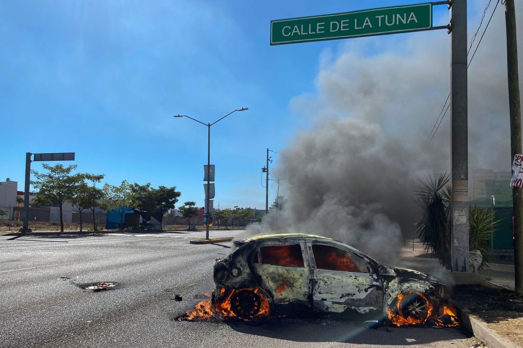 A burning car is seen on the street during an operation to arrest the son of Joaquin "El Chapo" Guzman, Ovidio Guzman, in Culiacan, Sinaloa state, Mexico, on January 5, 2023.