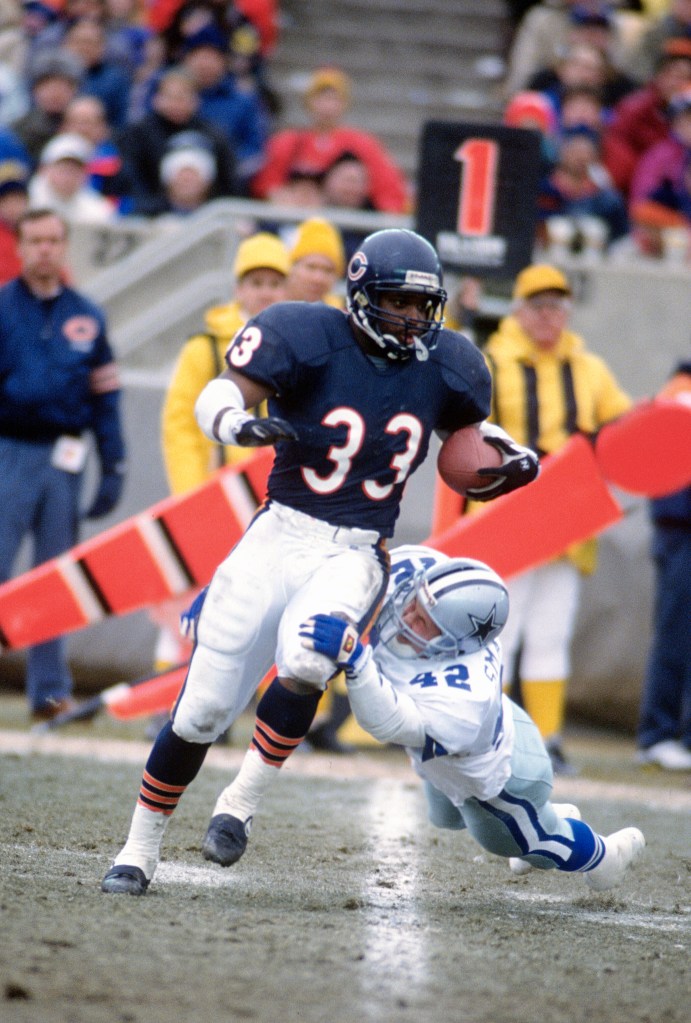 Darren Lewis returning a kickoff runs through the tackle of Stan Smagala during the NFC Divisional Playoff Game on December 29, 1991 at Soldier Field in Chicago, Illinois. 