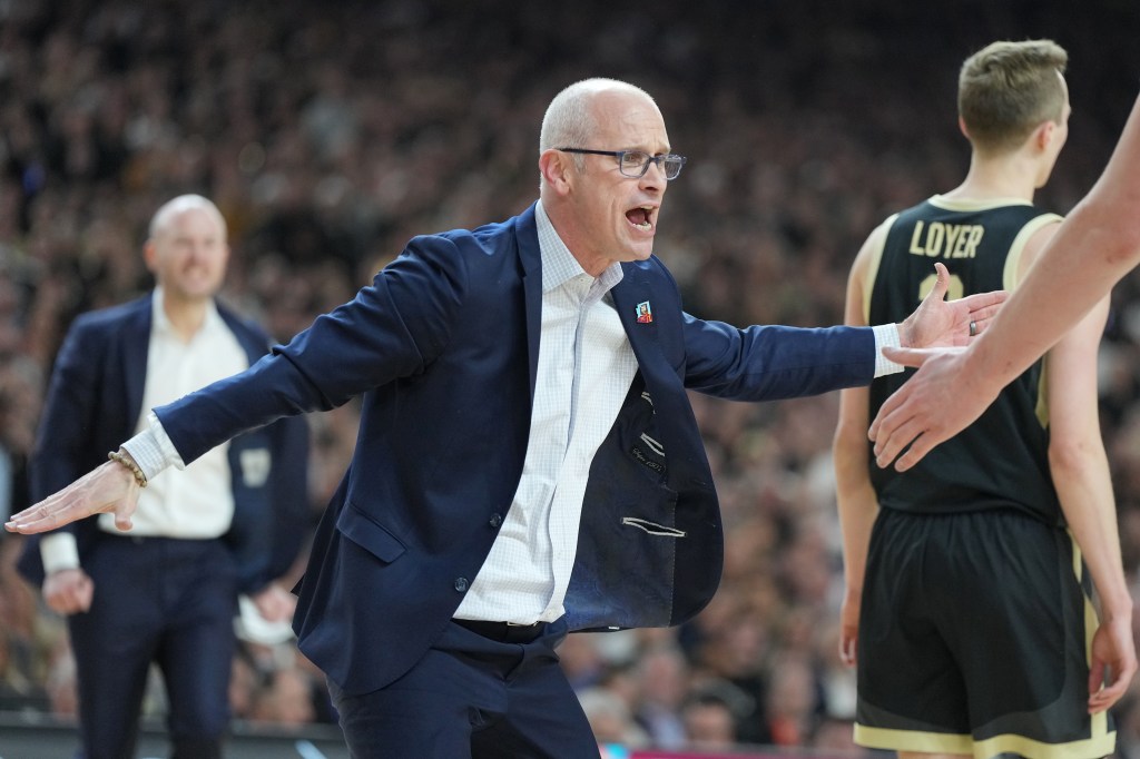 Dan Hurley celebrates a shot during the National College Basketball Championship game against the Purdue Boilermakers at State Farm Stadium on April 8, 2024 in Glendale, Arizona.