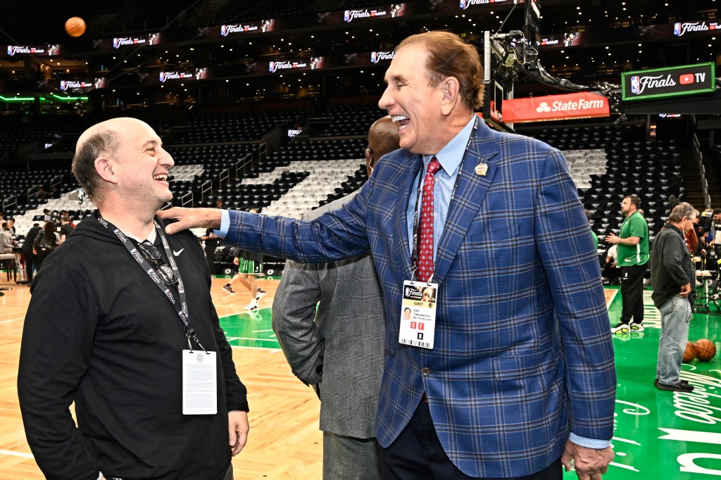 Jeff Van Gundy and Rudy Tomjanovich embracing on the basketball court prior to the game between Dallas Mavericks and Boston Celtics during 2024 NBA Finals