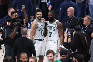 Jaylen Brown #7 and Jayson Tatum #0 of the Boston Celtics embrace after the game against the Dallas Mavericks during Game 3 of the 2024 NBA Finals on June 12, 2024 at the American Airlines Center in Dallas, Texas