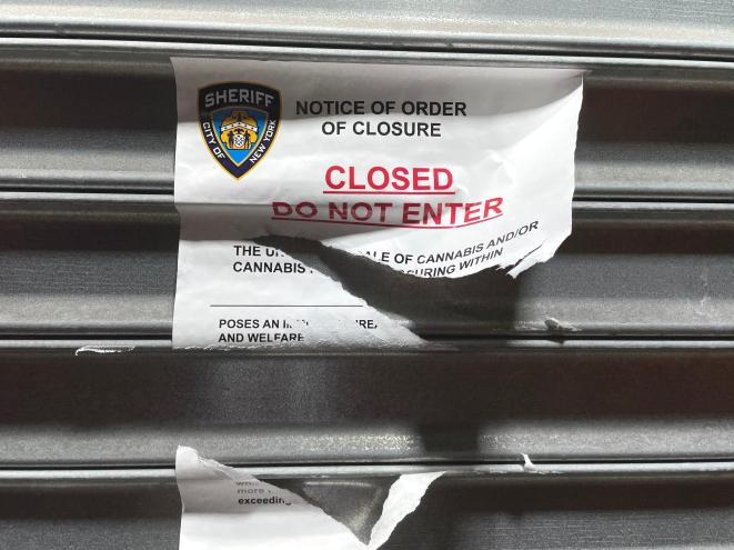 Notice of order closure on a garage door of an unlicense pot shop