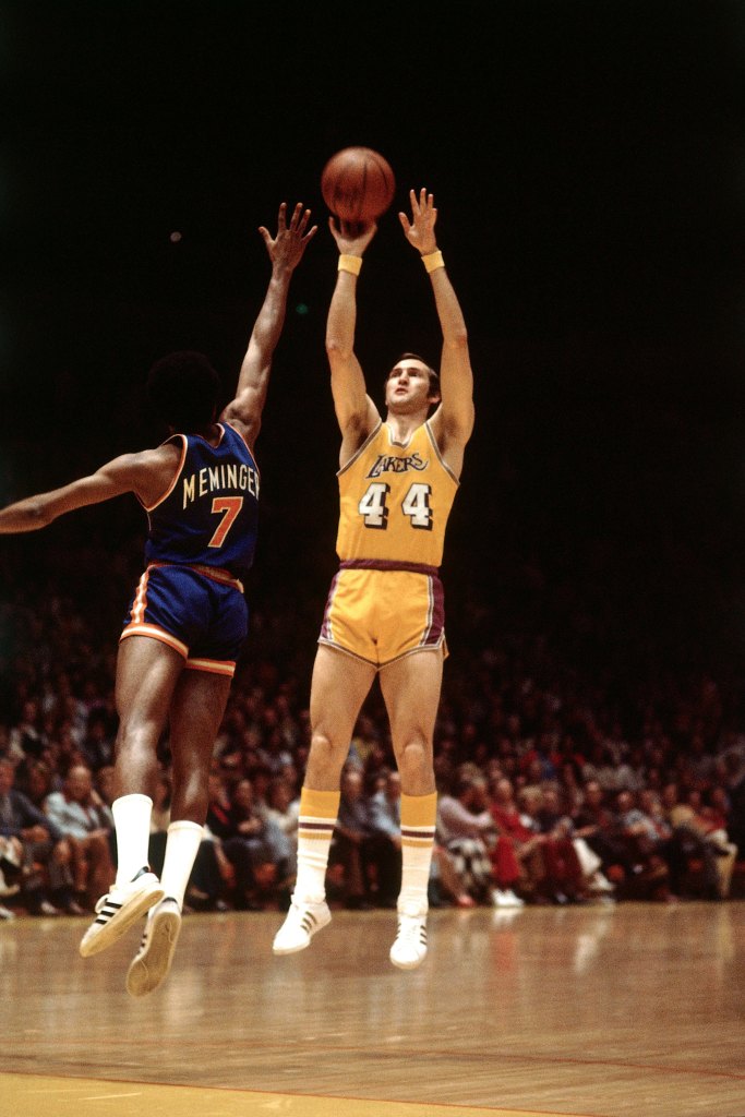 Jerry West #44 of the Los Angeles Lakers shooting a jump shot against Dean Meminger #7 of the New York Knicks during a 1975 NBA game
