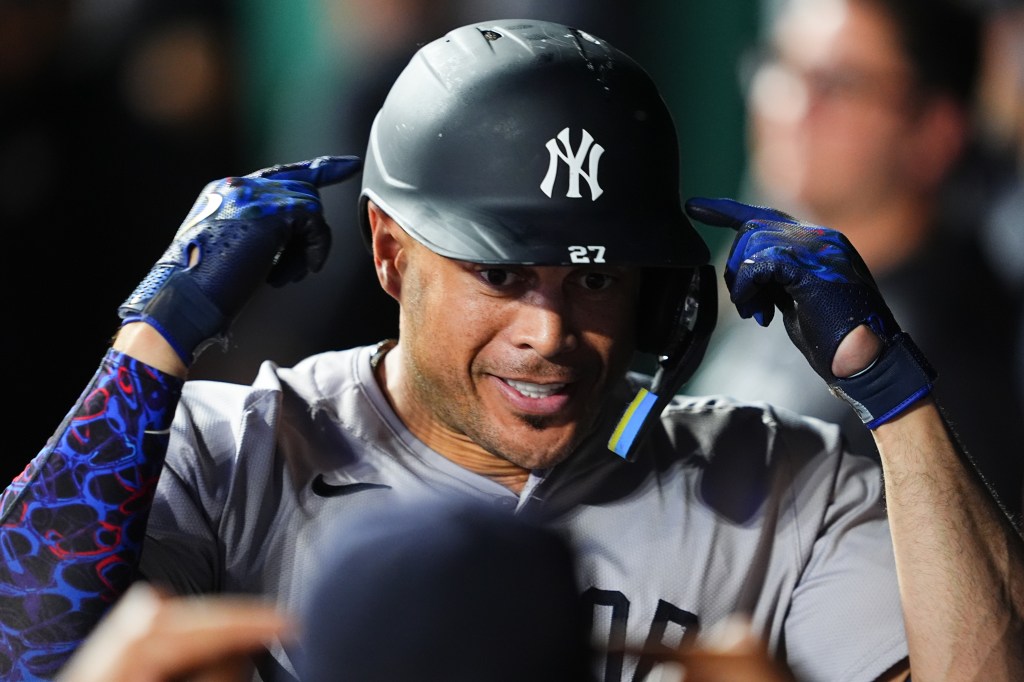 Giancarlo Stanton is all smiles after belting a solo homer in the seventh inning of the Yankees' victory.