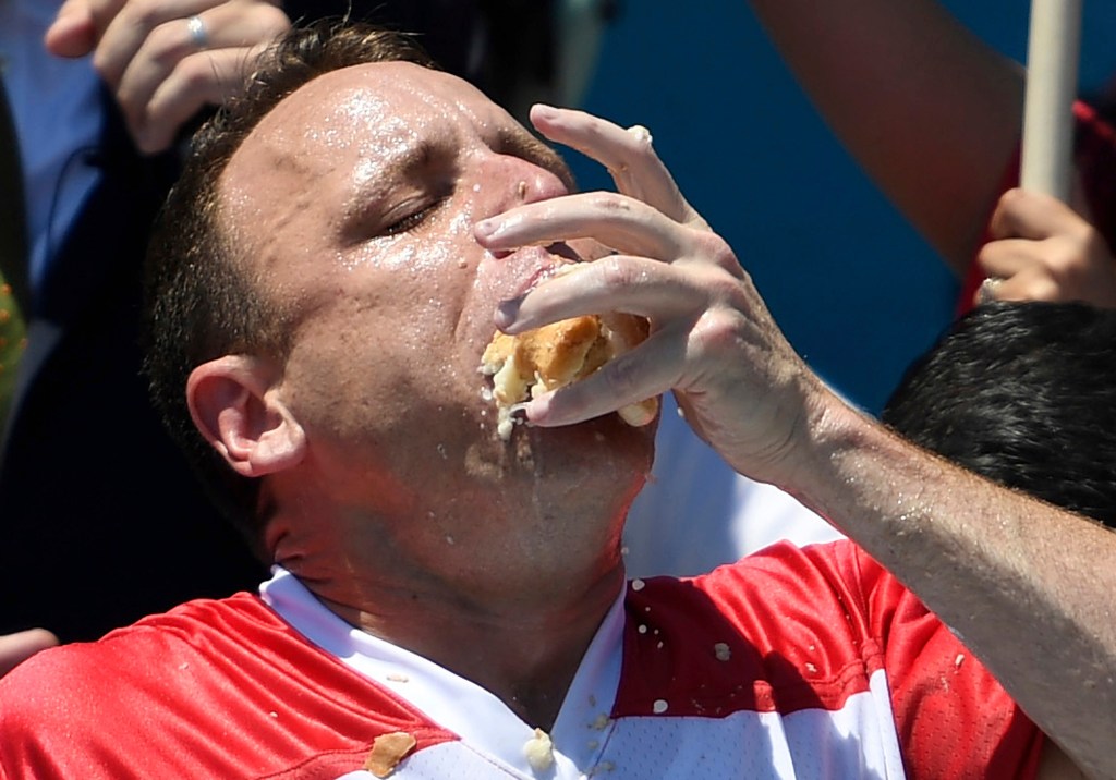 Joey Chestnut stuffs his mouth with hot dogs during the men's competition of Nathan's Famous July Fourth hot dog eating contest, July 4, 2019, in New York's Coney Island. Organizers announced on Tuesday, June 11, 2024
