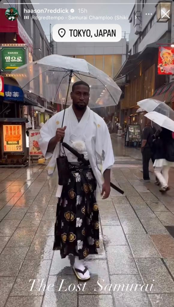 Haason Reddick strolls the streets of Tokyo, Japan while he is supposed to be at the Jets' training camp in New Jersey.