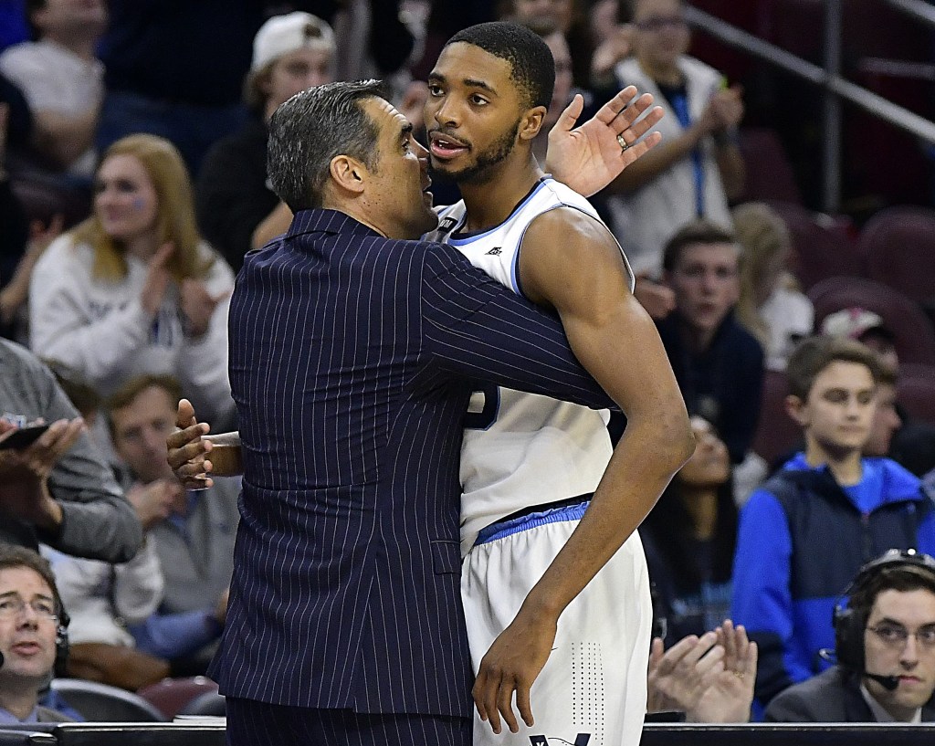 Jay Wright embraces Mikal Bridges, who is now with the Knicks, during a Villanova game in 2018.