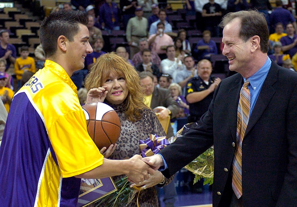 Josh Maravich, left, shakes hands with coach John Brady as his mother, Jackie Maravich, center, watches during Senior Day events before LSU's game against Vanderbilt on March 5, 2005, at the Pete Maravich Assembly Center. Josh, the son of the late Hall of Fame legend, died at age 42.