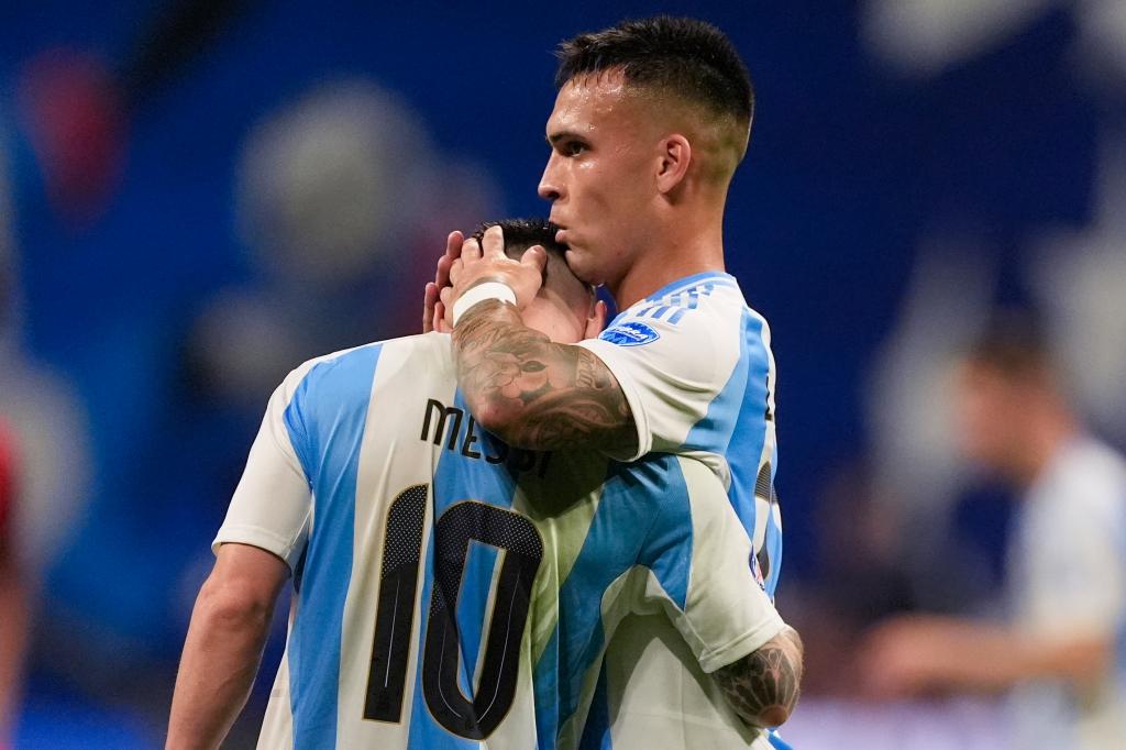 Lautaro Martinez (right), who scored a goal on a Lionel Messi assist, hugs the Argentina star after its Copa America victory.