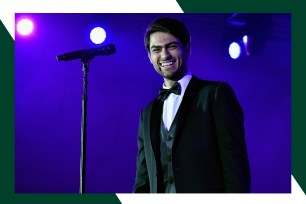 Matteo Bocelli smiles while standing onstage.