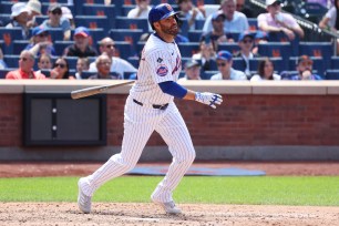 Mets designated hitter J.D. Martinez follows through on an RBI double during the fourth inning on Sunday against the Padres at Citi Field. 
