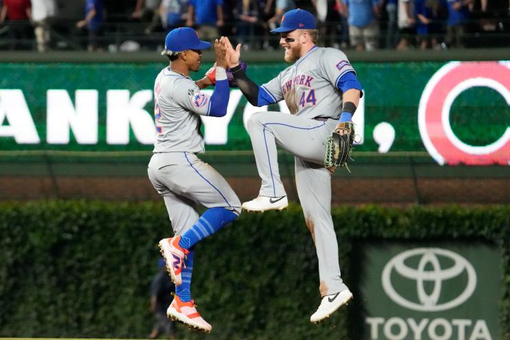 New York Mets' Francisco Lindor, left, celebrates with Harrison Bader after the Mets defeated the Chicago Cubs 5-2 in a baseball game in Chicago, Sunday, June 23, 2024