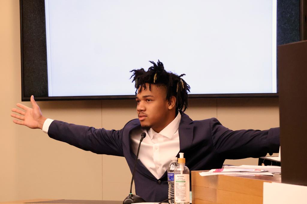University of Illinois basketball standout Terrence Shannon Jr. demonstrates his wingspan while testifying during his rape trial Thursday June 13, 2024, in Lawrence, Kan. 