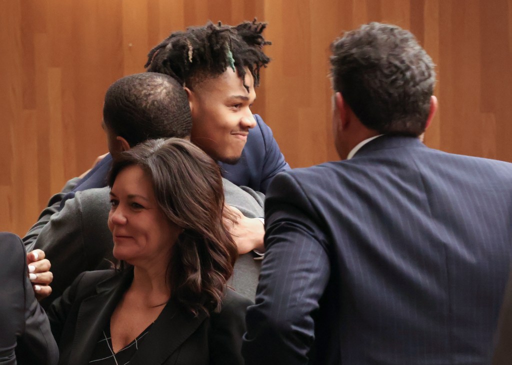 University of Illinois basketball standout Terrence Shannon Jr., center, gets a hug after being found not guilty after his sexual assault trial Thursday, June 13, 2024, in Lawrence, Kan. 