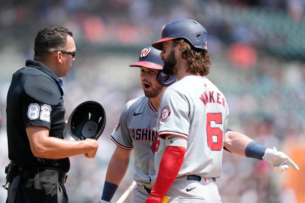 Washington Nationals' Lane Thomas, center, argues the strike zone with home plate umpire Emil Jimenez.