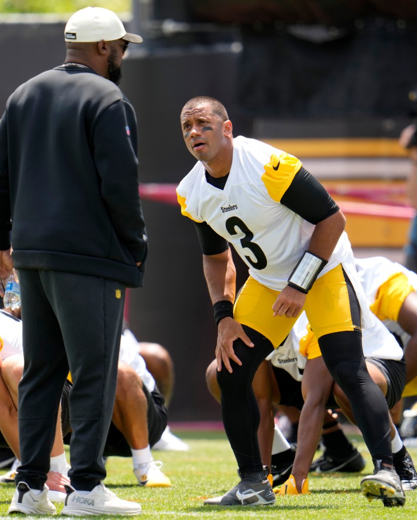 Pittsburgh Steelers quarterback Russell Wilson (3) listens to head coach Mike Tomlin while stretching during the team's NFL mini-camp football practice in Pittsburgh