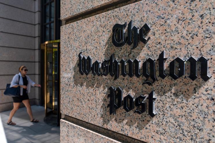 A person walks into the One Franklin Square Building, home of The Washington Post newspaper, Friday, June 21, 2024, in Washington.
