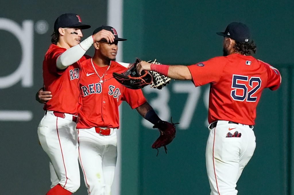 Boston Red Sox outfielders Jarren Duran, Ceddanne Rafaela and Wilyer Abreu celebrating after a victory against the Detroit Tigers