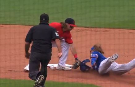 Justin Turner has his helmet tagged and was later ruled safe after replay.