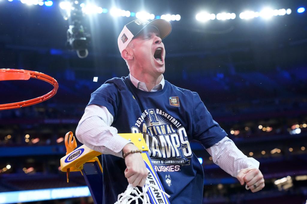 Connecticut Huskies head coach Dan Hurley cutting down the net after winning the national championship against the Purdue Boilermakers in the 2024 NCAA Tournament