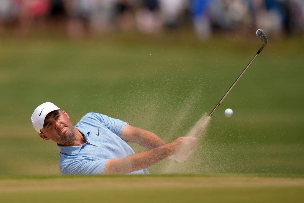 Scottie Scheffler hits from the bunker on the 10th hole during the third round of the U.S. Open golf tournament Saturday, June 15, 2024