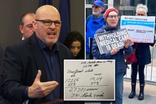 A man speaking to another man holding a sign