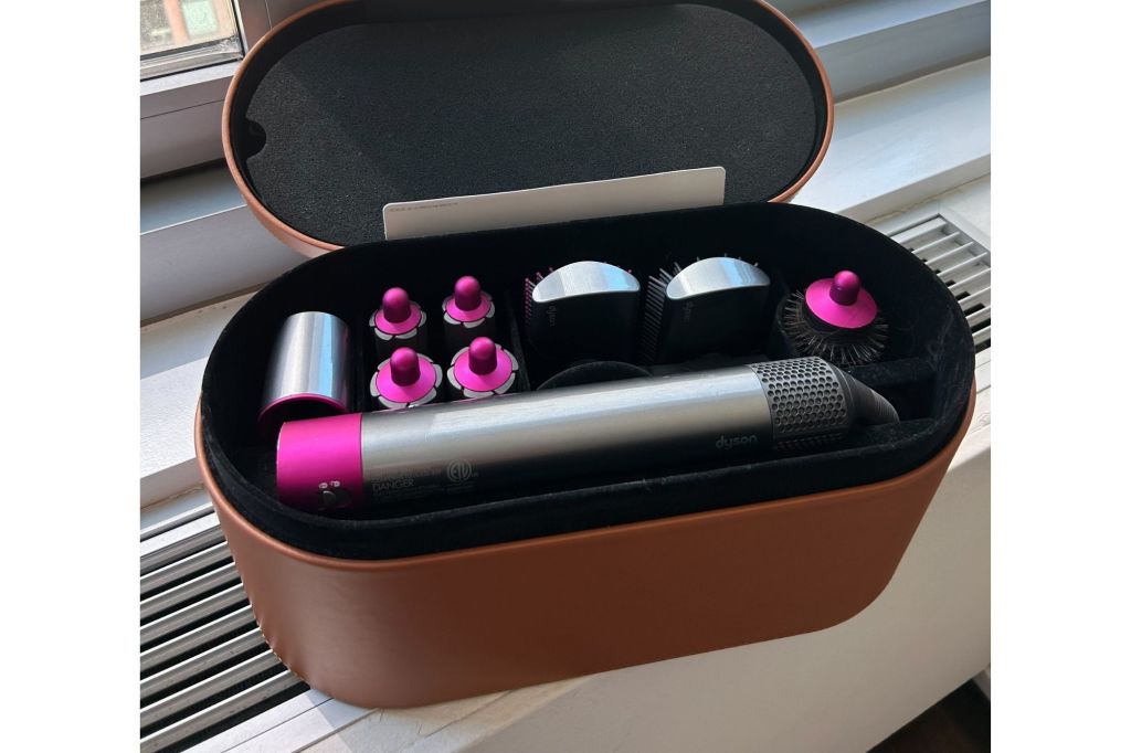 A Dyson AirWrap in grey and pink.