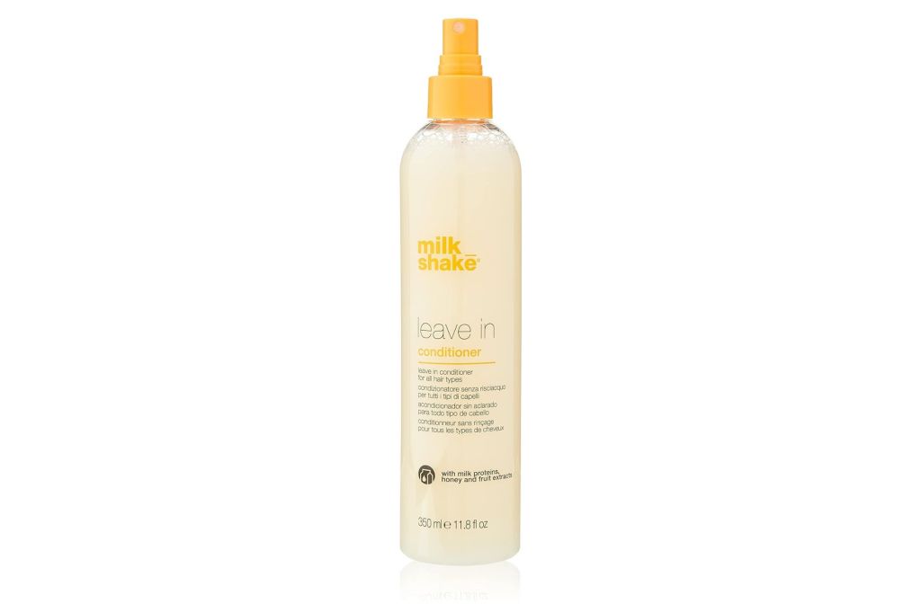 A leave in conditioner in a clear bottle with a yellow cap.