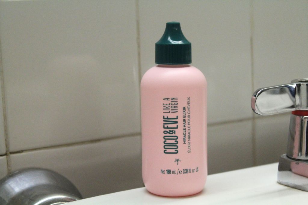 A pink bottle with a green cap.
