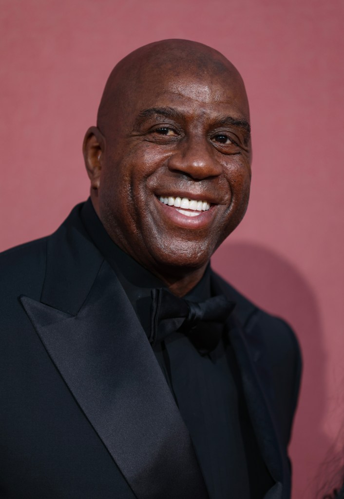 Magic Johnson smiling in a suit at the amfAR Cannes Gala 30th edition in Cap d'Antibes, France