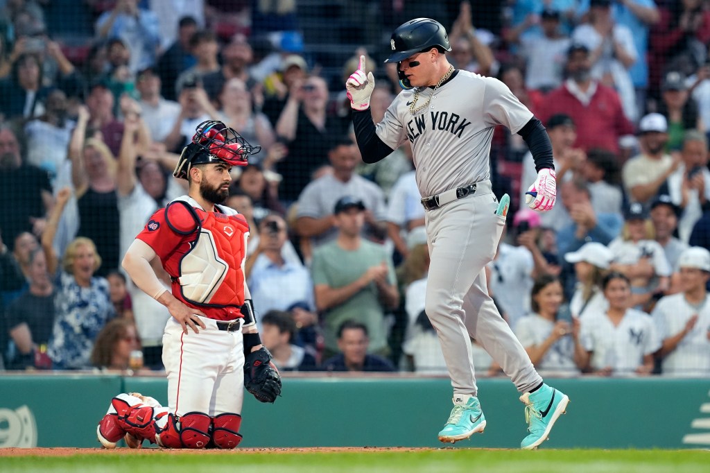 New York Yankees' Alex Verdugo celebrates his two-run home run, next to Boston Red Sox catcher Reese McGuire during the first inning of a baseball game Friday, June 14, 2024, in Boston.