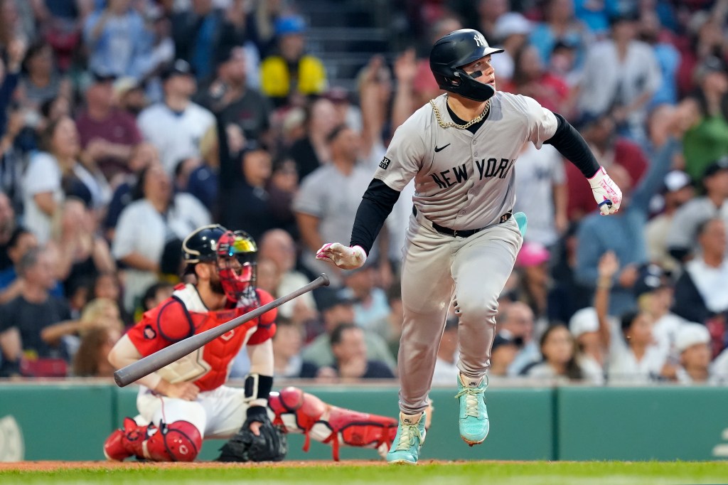 New York Yankees' Alex Verdugo leaves the batter's box on his two-run home run, in front of Boston Red Sox catcher Reese McGuire during the first inning of a baseball game Friday, June 14, 2024