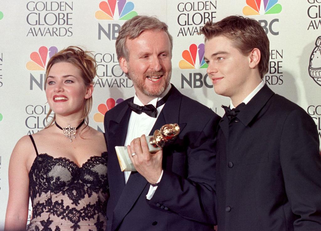 Director James Cameron(C), Winslet(L) and DiCaprio(R) pose for pictures after Cameron won the award for Best Director for "Titanic"  at the 55th Annual Golden Globe Awards. 