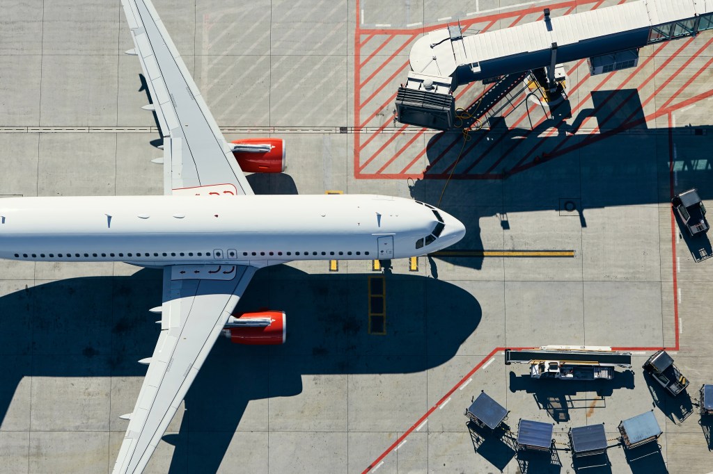 Aerial view of an Air France airplane in Euro white color taxiing to the terminal at an airport