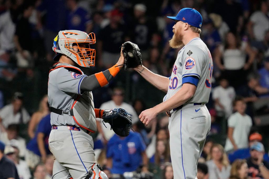 New York Mets catcher Francisco Alvarez, left, celebrates with relief pitcher Jake Diekman after the Mets defeated the Chicago Cubs 5-2 in a baseball game in Chicago, Sunday, June 23, 2024. 