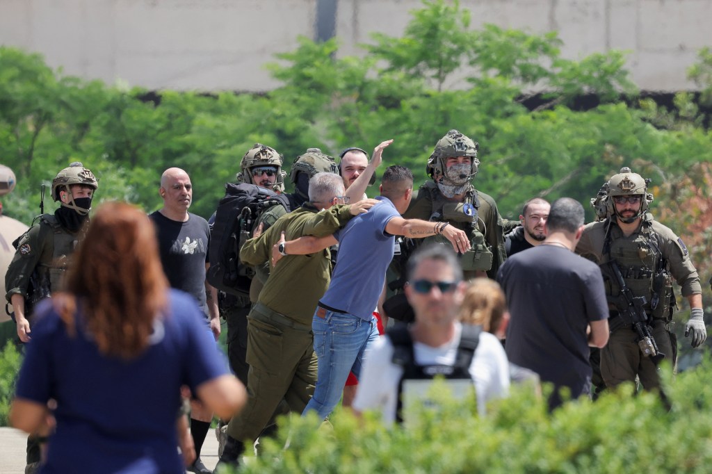 Shlomi Ziv (on the left in the gray shirt) was rescued during an IDF raid.