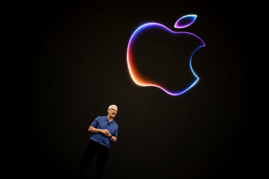 Apple CEO Tim Cook standing in front of a large logo at the 2024 Apple Worldwide Developers Conference in Cupertino, California