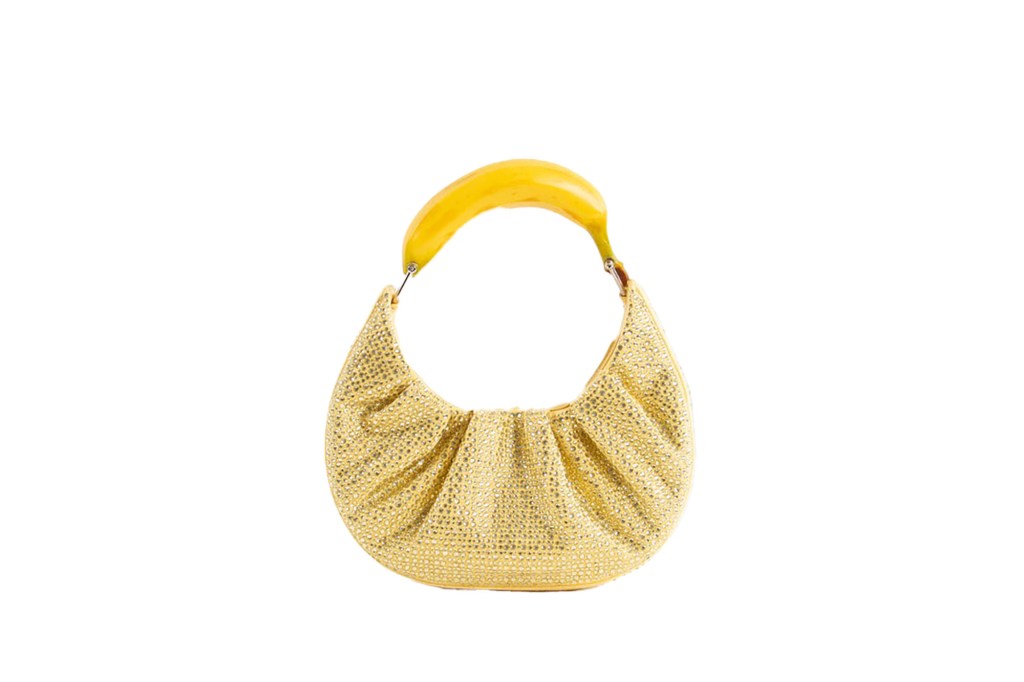 A banana resting on a purse