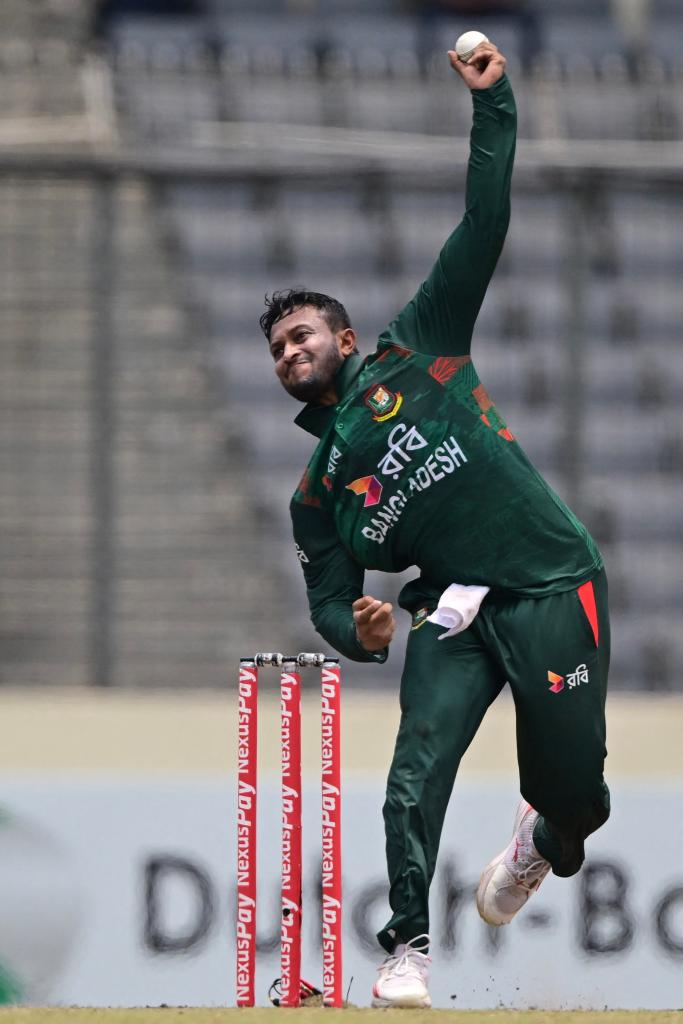 Bangladesh's Shakib Al Hasan in green sports uniform delivering a ball during a Twenty20 international cricket match against Zimbabwe