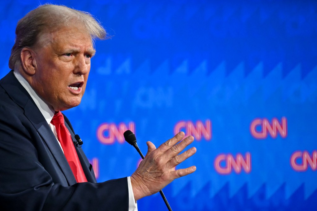 Former US President Donald Trump speaking into a microphone during the first presidential debate of the 2024 elections 