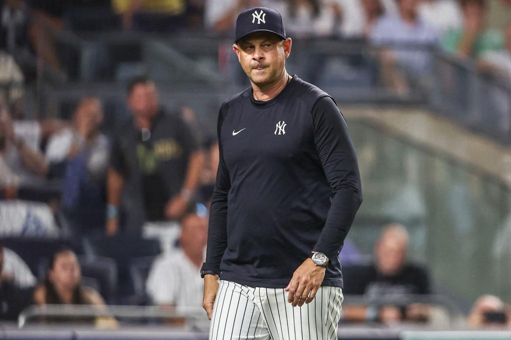 New York Yankees manager Aaron Boone (17) walks off the field after being ejected in the seventh inning against the Atlanta Braves at Yankee Stadium. 