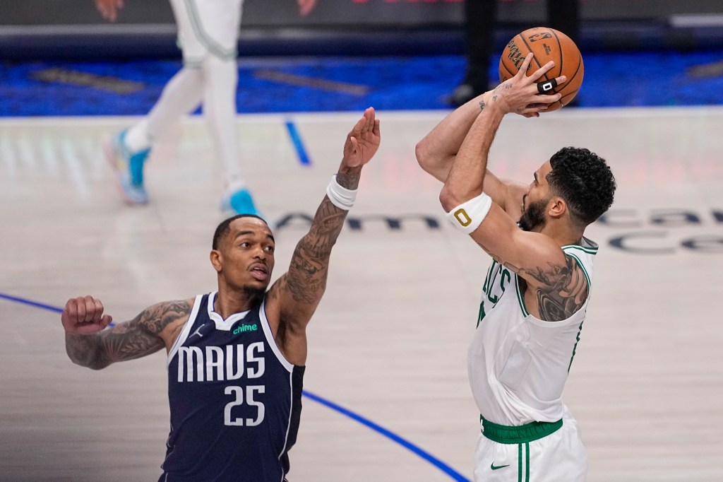 Boston Celtics forward Jayson Tatum, right, shoots against Dallas Mavericks forward P.J. Washington during the second half in Game 3 of the NBA basketball finals, Wednesday, June 12, 2024, in Dallas.