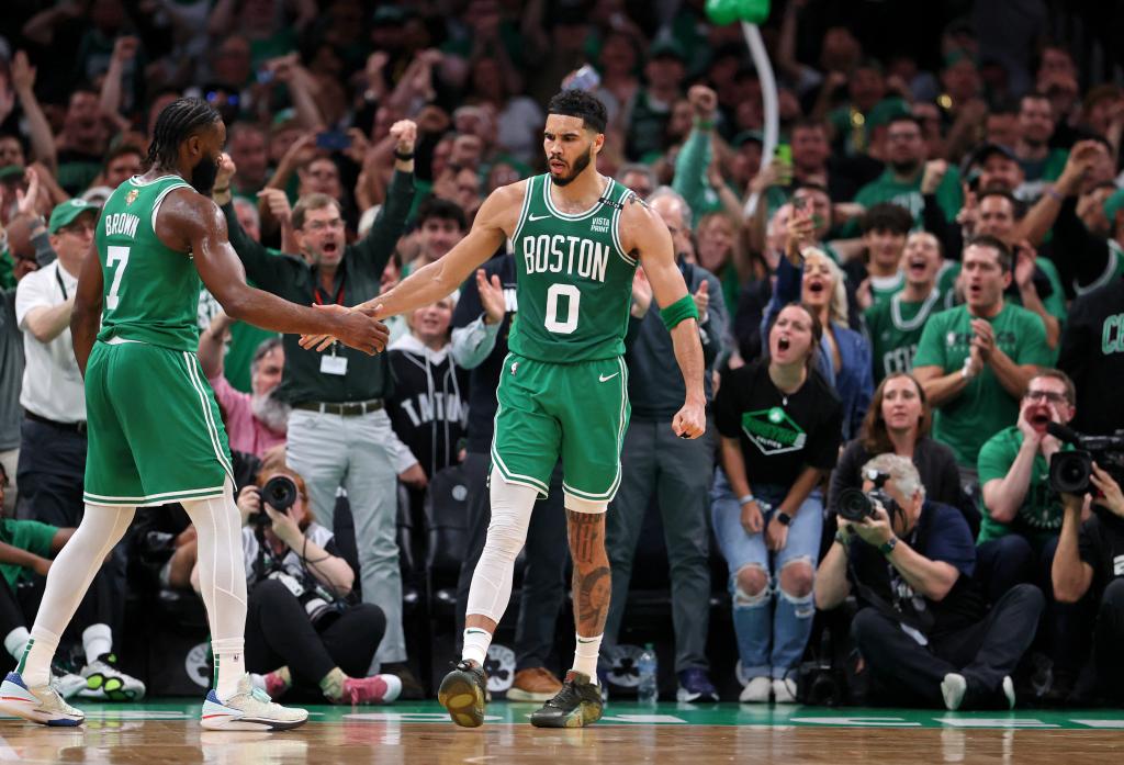 Boston Celtics players Jayson Tatum and Jaylen Brown celebrating a play during 2024 NBA Finals game against the Dallas Mavericks